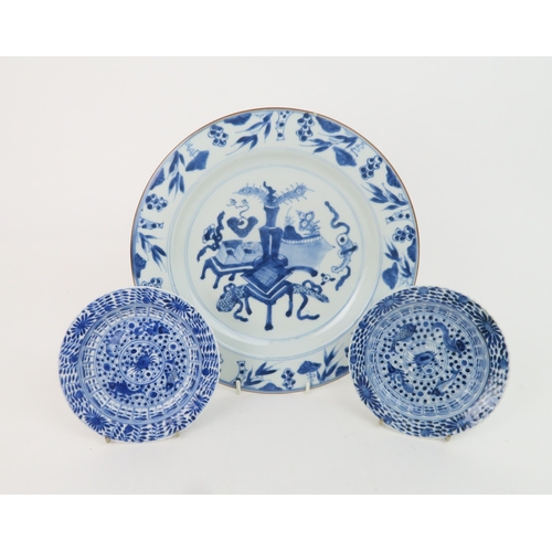 323 - A CHINESE BLUE AND WHITE DISHpainted with precious objects, within a foliate band, 27.5cm diameter, ... 