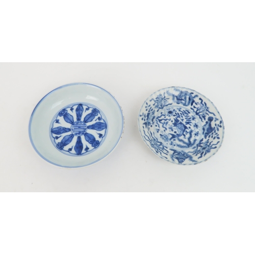 323 - A CHINESE BLUE AND WHITE DISHpainted with precious objects, within a foliate band, 27.5cm diameter, ... 