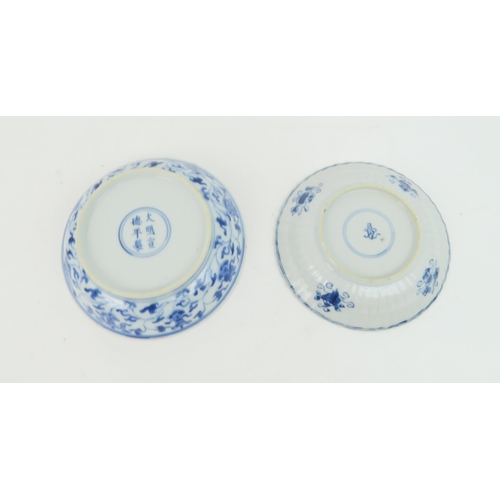 323 - A CHINESE BLUE AND WHITE DISHpainted with precious objects, within a foliate band, 27.5cm diameter, ... 