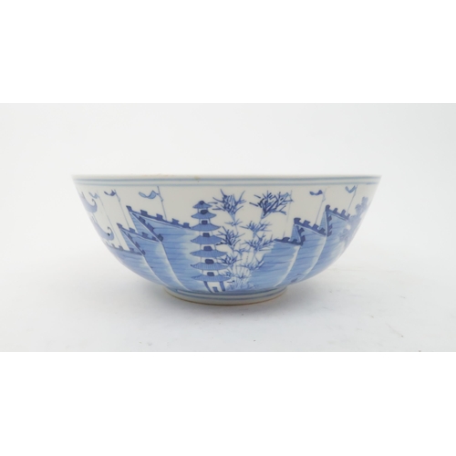 324 - A CHINESE BLUE AND WHITE PUNCH BOWL painted pagodas on islands, 30cm diameter and another paint... 