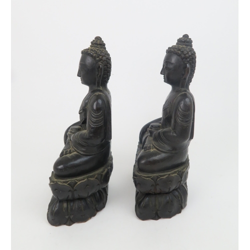 325 - A PAIR OF ASIAN HARDWOOD CARVINGS OF BUDDHAeach seated on a lotus base, 31cm high... 