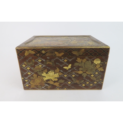 329 -  A JAPANESE GOLD LACQUERED BOXwith shaped cover and base drawer,decorated with birds, butterfli... 