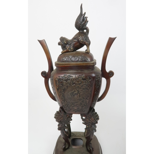 332 - A CHINESE BRONZE AND ENAMEL INCENSE BURNERcast with shishi and decorated with taotie masks, 37cm hig... 