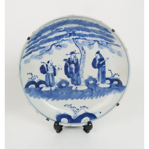 339 - A CHINESE BLUE AND WHITE DISHpainted with a mandarin, sage and officials in a garden and beneath a p... 