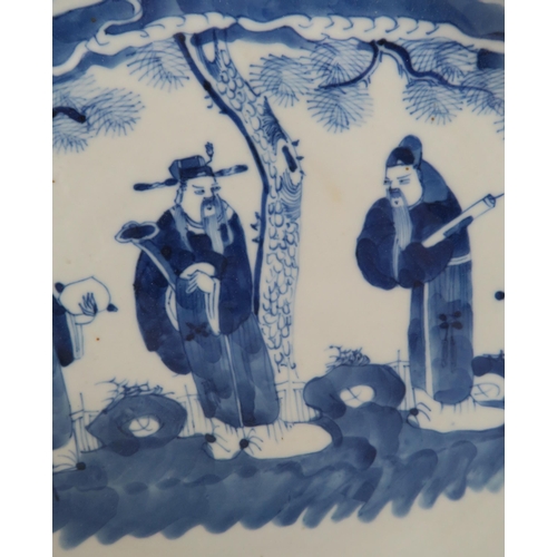 339 - A CHINESE BLUE AND WHITE DISHpainted with a mandarin, sage and officials in a garden and beneath a p... 