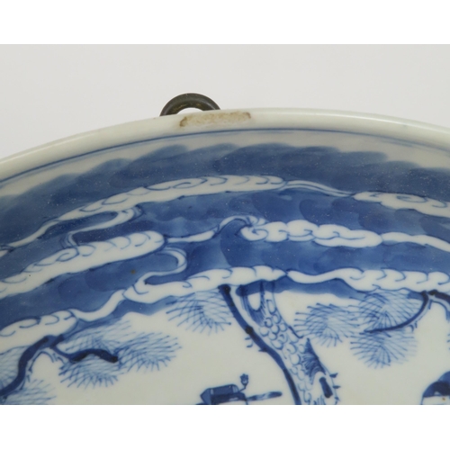 339 - A CHINESE BLUE AND WHITE DISHpainted with a mandarin, sage and officials in a garden and beneath a p... 