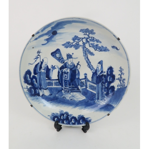 339 - A CHINESE BLUE AND WHITE DISHpainted with a mandarin, sage and officials in a garden and beneath a p... 