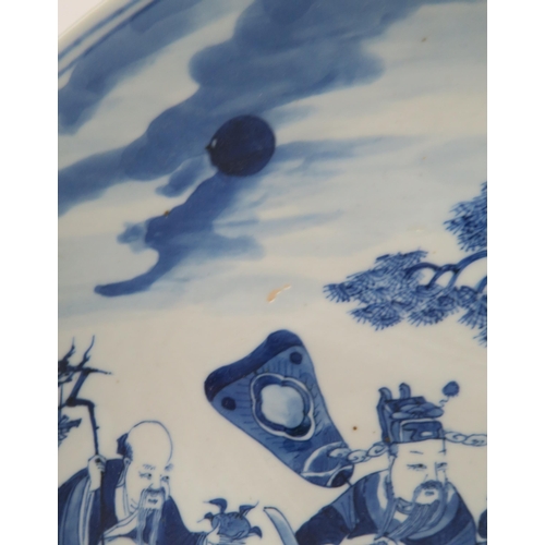 339 - A CHINESE BLUE AND WHITE DISHpainted with a mandarin, sage and officials in a garden and beneath a p... 