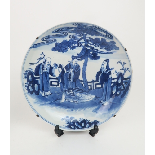 340 - TWO CHINESE BLUE AND WHITE DISHESpainted with a mandarin, sage and officials in a garden and beneath... 