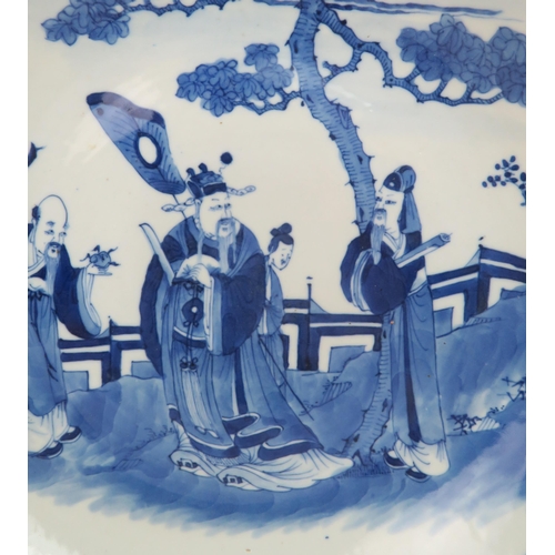 340 - TWO CHINESE BLUE AND WHITE DISHESpainted with a mandarin, sage and officials in a garden and beneath... 