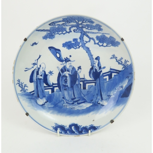 340 - TWO CHINESE BLUE AND WHITE DISHESpainted with a mandarin, sage and officials in a garden and beneath... 