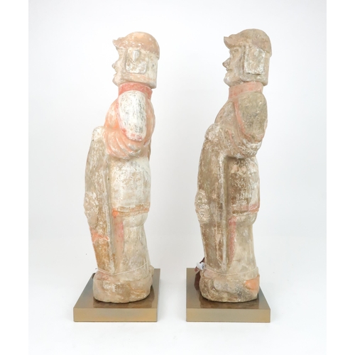 349 - A PAIR OF PAINTED RED POTTERY FIGURES OF SOLDIERSmodelled standing to attention with fierce expressi... 