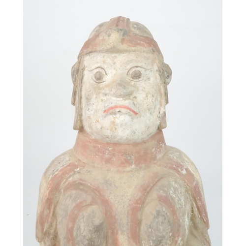 350 - A PAINTED POTTERY MODEL OF A SOLDIERmodelled standing to attention, with a fierce expression, holdin... 