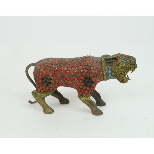 367 - AN INDIAN GILT METAL AND JEWELLED MODEL OF A TIGERon all fours with snarling expression, 15cm long a... 