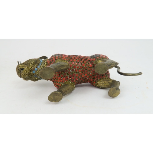 367 - AN INDIAN GILT METAL AND JEWELLED MODEL OF A TIGERon all fours with snarling expression, 15cm long a... 