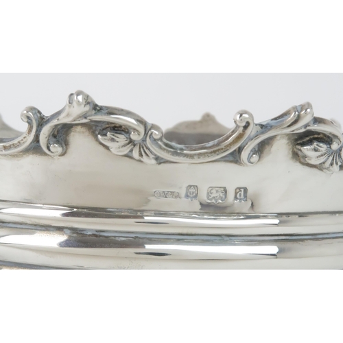 402 - AN EDWARDIAN SILVER POT / PLANTERof tapering cylindrical form, the body with pierced fretwork vignet... 