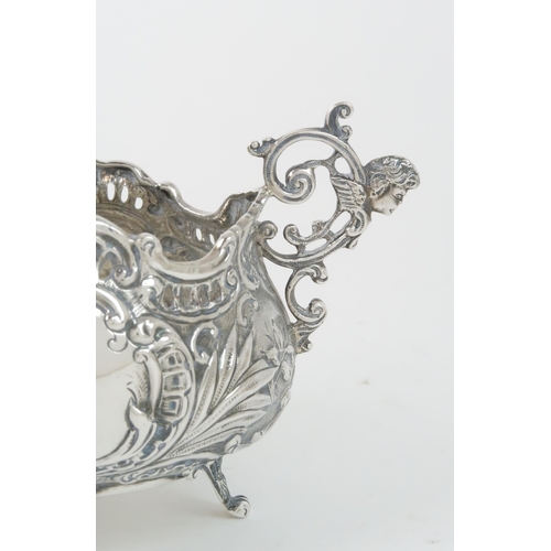 402 - AN EDWARDIAN SILVER POT / PLANTERof tapering cylindrical form, the body with pierced fretwork vignet... 