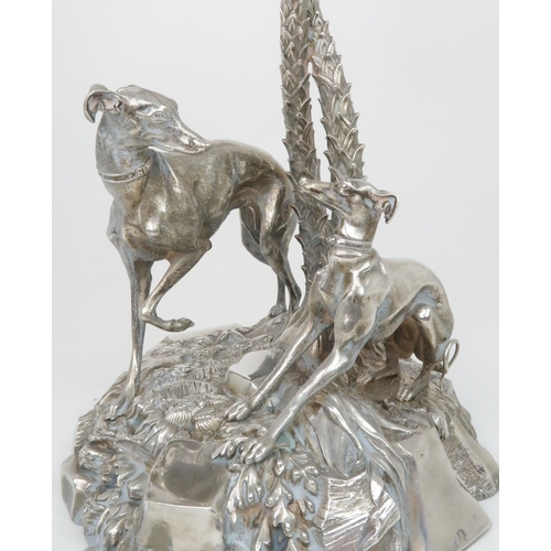 404 - A VICTORIAN SILVER PLATED CENTREPIECEmodelled as a pair of greyhounds on a grassy outcrop with two e... 