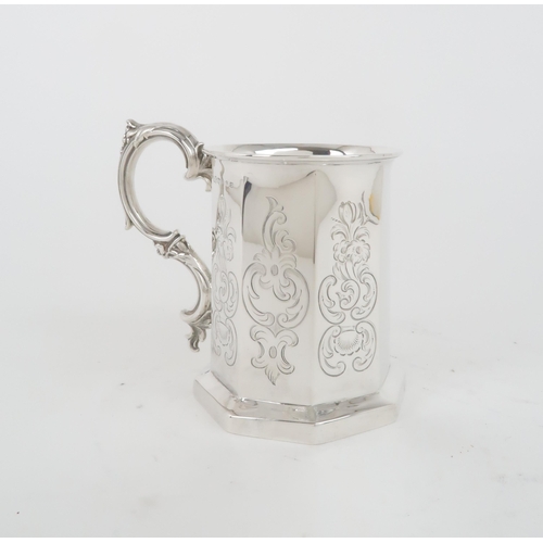 405 - A VICTORIAN SILVER TANKARDof faceted form, with engraved scrolling foliate decoration to each panel,... 