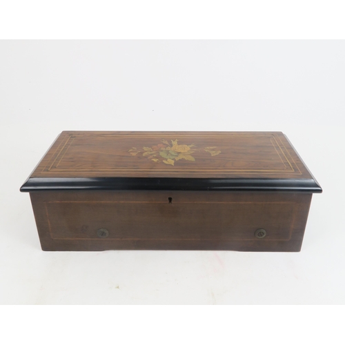 506 - A CONTINENTAL MUSICAL BOXthe rosewood veneered marquetry case enclosing a glazed cover above the mov... 