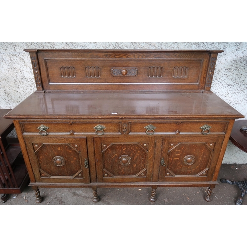 132 - A 20th century oak sideboard with two drawers over three cabinet doors (treated previously for worm)