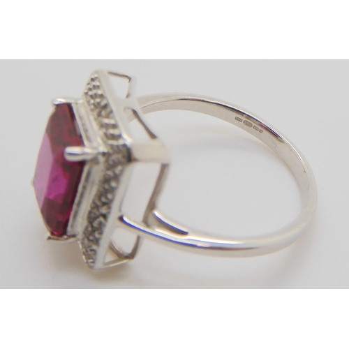 572 - A 9ct white gold and diamond ring with a lab created ruby, size M, with point of sale paperwork, tog... 