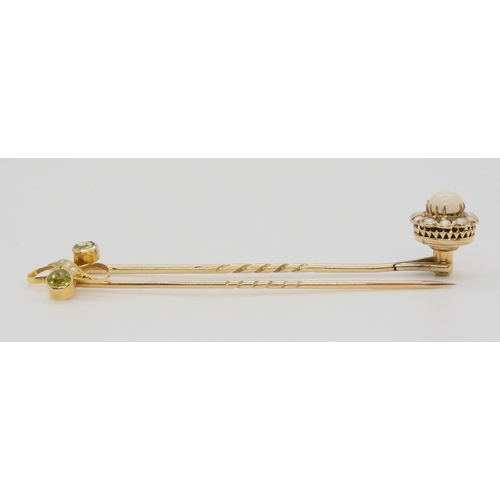 584 - A bright yellow metal peridot and pearl stick pin, together with a yellow metal opal and pearl pin, ... 