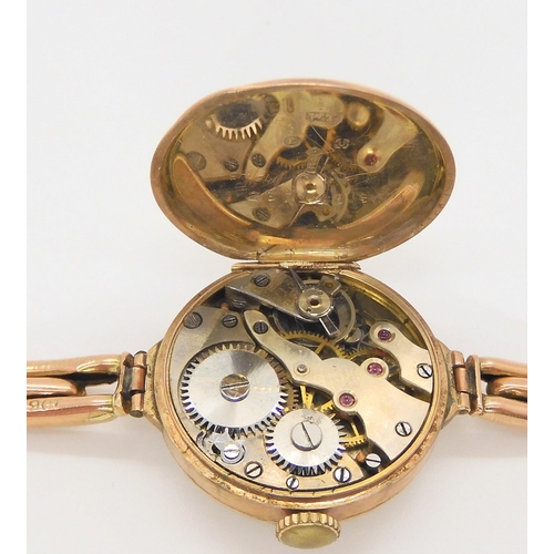 586 - A 9ct gold ladies vintage watch and strap, London import hallmarks for 1920, weight including mechan... 