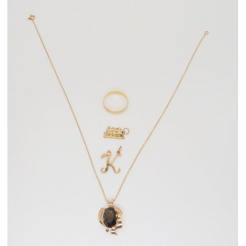 588 - A 9ct gold smokey quartz pendant and chain, wedding ring size V, and two pendants, weight combined 7... 