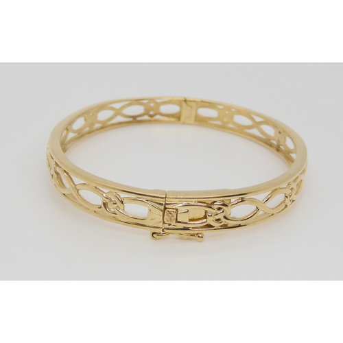 595 - A 9ct gold celtic knotwork pattern bangle, weight 12.8gms