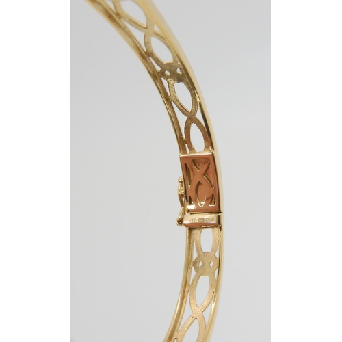 595 - A 9ct gold celtic knotwork pattern bangle, weight 12.8gms