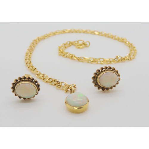 603 - An 18ct gold white opal pendant weight 1.2gms on a 9ct gold chain with similar 9ct earrings weight a... 