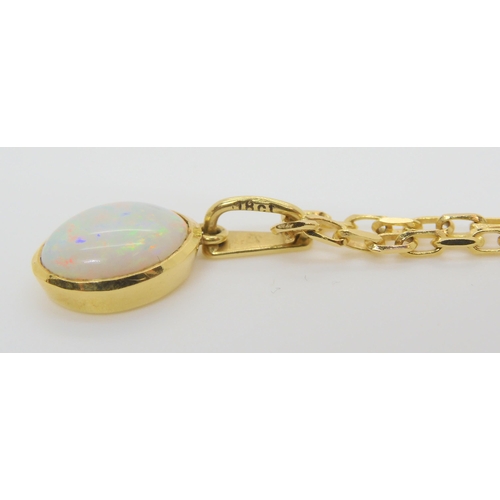 603 - An 18ct gold white opal pendant weight 1.2gms on a 9ct gold chain with similar 9ct earrings weight a... 