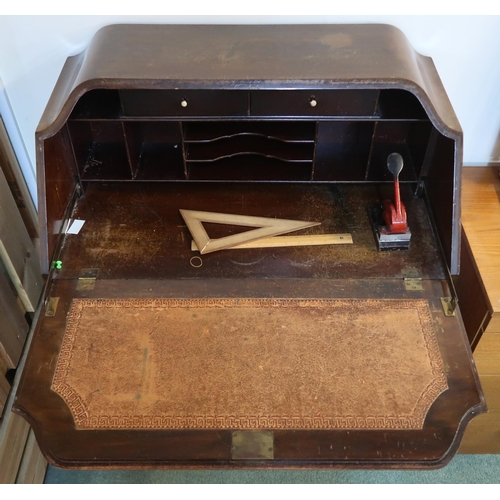 63 - A 20th century mahogany writing bureau with fitted fall front writing compartment over three drawers... 