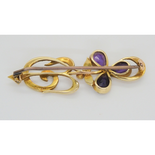 635 - A 15ct gold Art Nouveau Iris flower brooch set with amethyst and pearl, length 4.5cm, weight 4.6gms