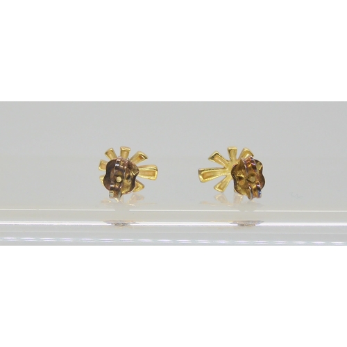 636 - A pair of 14k gold (stamped 585) diamond flower earrings, set with 2 x 0.04ct diamonds, with secure ... 