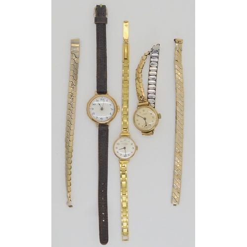 649 - A vintage 9ct gold cased watch with leather strap together with two other 9ct gold watch heads with ... 