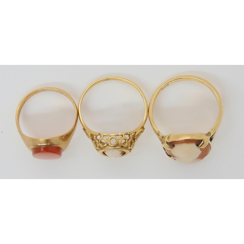 669 - Three 9ct gold rings, a cameo ring size L1/2, a smaller example size K1/2 and a carnelian signet rin... 