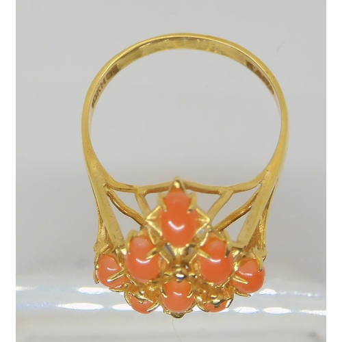 681 - A bright yellow metal coral cluster ring, the shank stamped K18, size O, weight 2.4gms