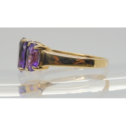 686 - A 9ct gold three amethyst and diamond accent ring, size P1/2, weight 3.2gms