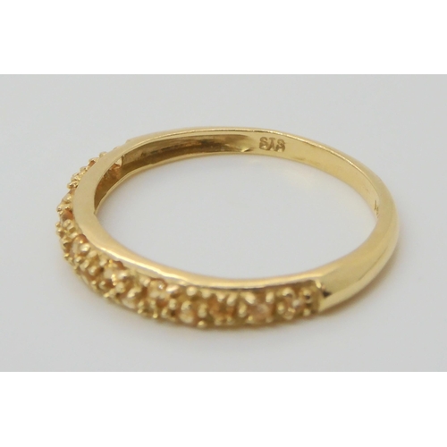 691 - A 14k gold full diamond eternity ring, size M, together with a champagne colour gem set band ring, s... 