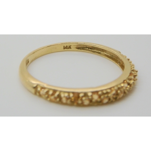 691 - A 14k gold full diamond eternity ring, size M, together with a champagne colour gem set band ring, s... 