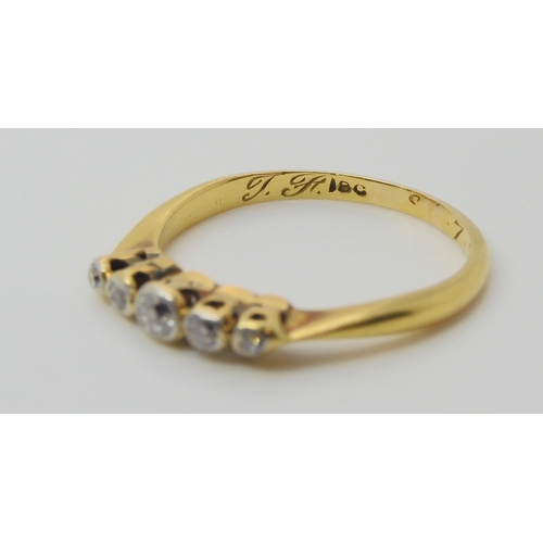 692 - An 18ct gold five stone diamond ring, set with estimated approx 0.15cts of old cut diamonds, size L1... 