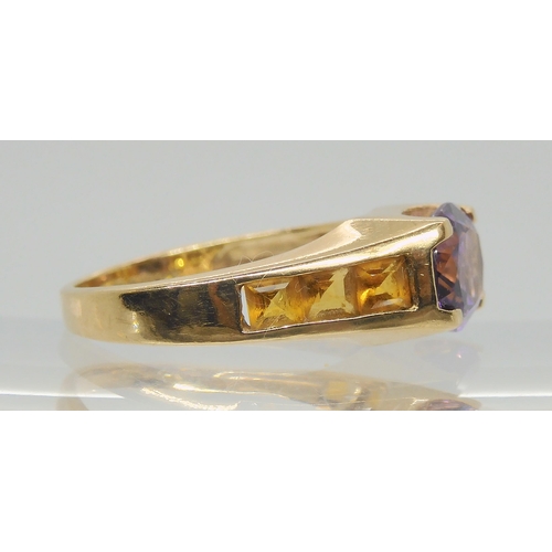 697 - A 9ct gold amethyst and citrine ring, size O, weight 3.6gms 