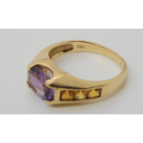 697 - A 9ct gold amethyst and citrine ring, size O, weight 3.6gms 