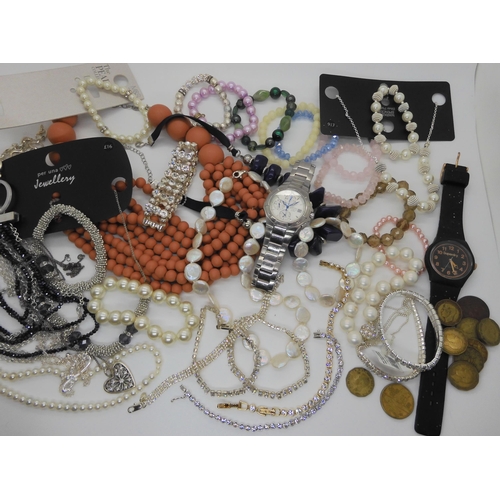 718 - A collection of thrupenny bits, costume jewellery and watches to include a button pearl necklace and... 