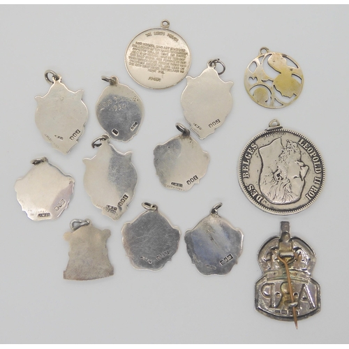 724 - A silver ARP badge, seven Irish silver medallions, with harp or shamrock motifs and other items