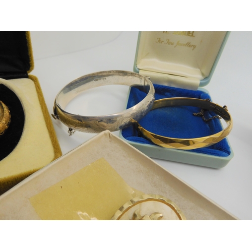 734 - A silver engraved bangle, a ladies vintage bangle watch in original box From Watches of Switzerland,... 