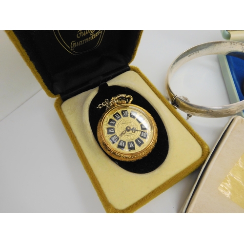 734 - A silver engraved bangle, a ladies vintage bangle watch in original box From Watches of Switzerland,... 