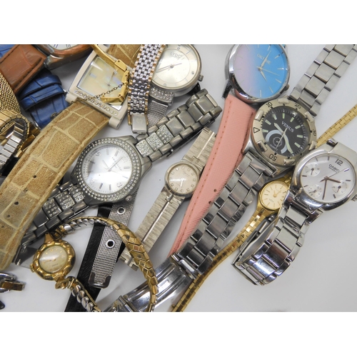 738 - A large collection of fashion watches to include Swatch